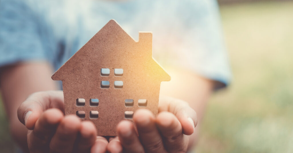 Cardboard house in hand