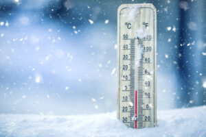 Thermometer,On,Snow,Shows,Low,Temperatures,In,Celsius,Or,Farenheit.