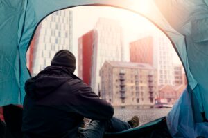 View,From,Inside,Of,A,Homeless,Tent.,Man,In,Dark